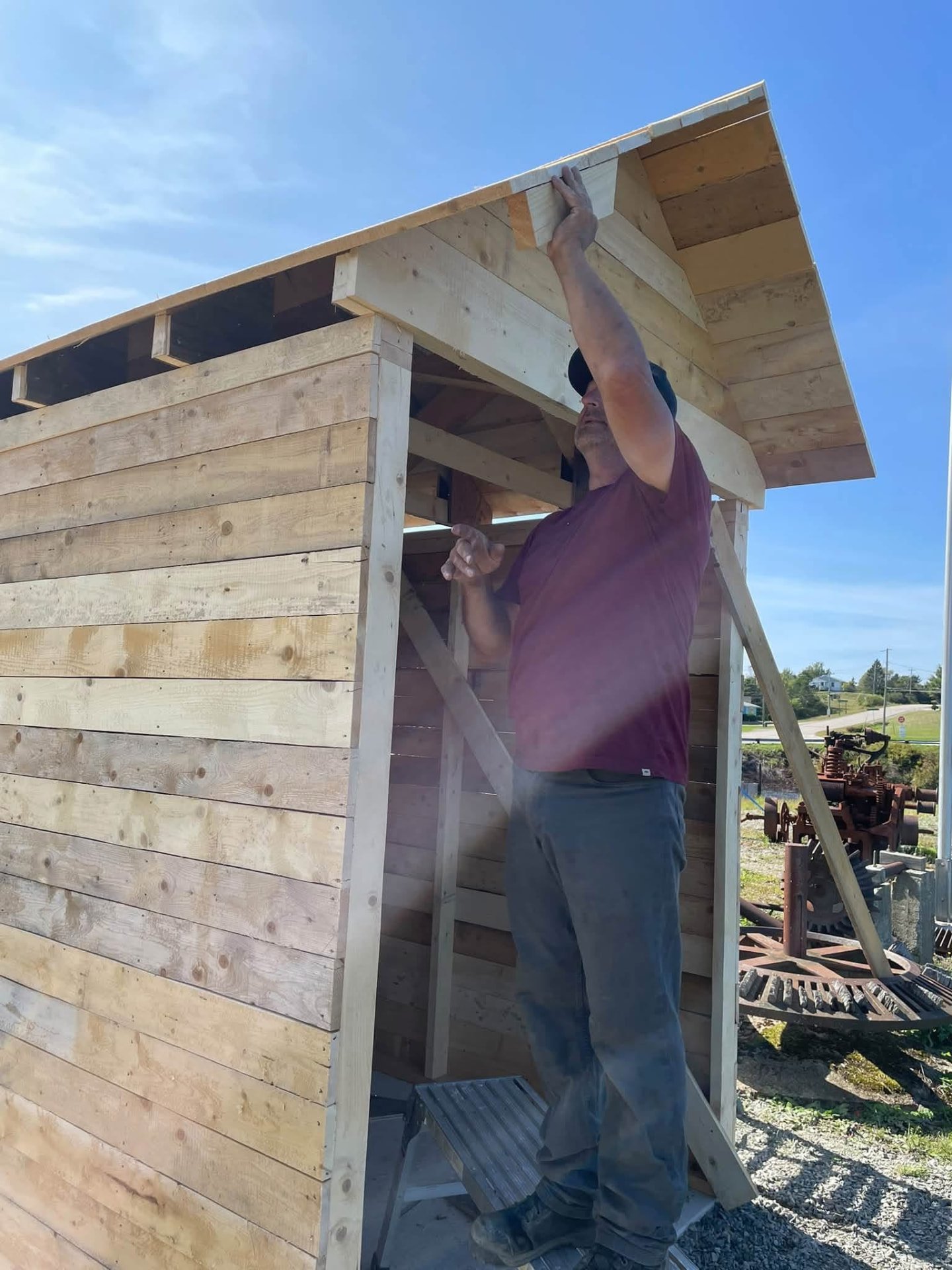 A volunteer installing the Wind Phone roof trim