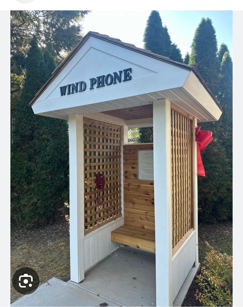 The Wind Phone — a wooden booth with a disconnected red phone, a quiet space for reflection and remembrance.